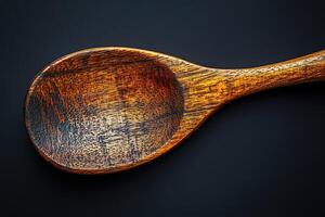 A wooden spoon with a black background photo