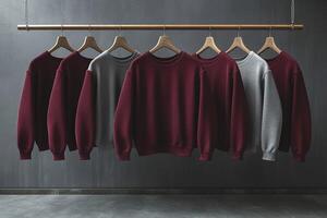 A row of clothes hanging on a rack, including a gray sweatshirt photo