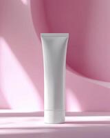 Mockup of cosmetic white tube cream 50ml on stone stand on pink background minimalist. Natural hard lighting and shadows photo