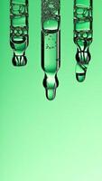 Pipette serum drop with niacinamide, hyaluronic or Aha Bha acids on a green isolated background photo