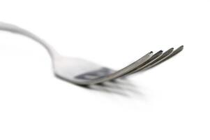 Metal fork rests on a white surface, showcasing its elegant design and fine craftsmanship in minimalistic style photo