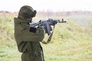 Man shooting at a target. Unformal shooting range photo