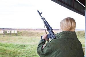 Man shooting at a target. Unformal shooting range photo