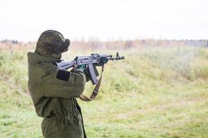 Man shooting at a target. Unformal shooting range photo