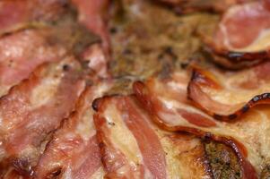 Sizzling slices of perfectly cooked bacon on a golden-brown crust ready for breakfast delight photo