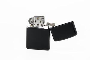 Classic metal lighter with sleek black finish and open lid ready for use in lighting fires photo