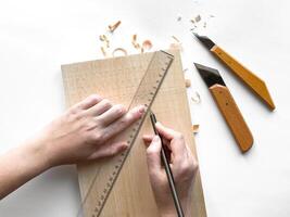 Hands crafting wood with precision tools and geometric patterns design photo