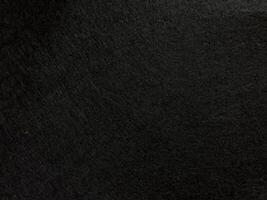 Dark textured surface background with subtle patterns and shadows photo