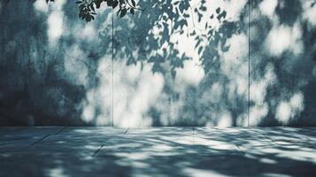 Shadow of a tree is cast on a concrete wall. The shadow is large and dark, creating a sense of depth and dimension. The contrast between the shadow and the wall adds a sense of drama photo