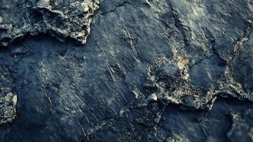 Blue rock with a rough surface. The rock is a dark blue color and has a rough texture photo