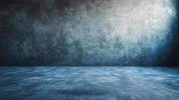 The room is a large, empty space with a blue wall. The walls are made of concrete and the floor is made of concrete as well. The room is devoid of any furniture or decorations, giving it a stark photo