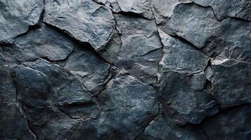 Close up of a rock wall with a lot of cracks and crevices. The wall is made of stone and he is very old. The cracks and crevices give the wall a rugged and weathered appearance photo