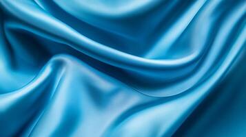 Blue fabric with a pattern of waves. The fabric is smooth and shiny. The blue color gives a sense of calmness and serenity photo