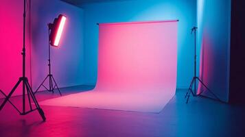 Studio with a pink backdrop and three lights. The studio is set up for photography or film production photo