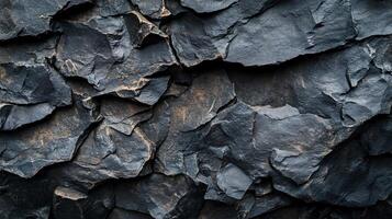Close up of a rock wall with a lot of texture. The wall is made of large rocks and has a rough, uneven surface. Concept of ruggedness and strength, as well as a connection to nature photo