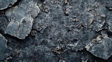 Rock with a lot of cracks and holes. The cracks are deep and the holes are small photo