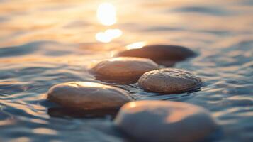 Group of rocks are floating in the water. The sun is shining on them, creating a peaceful and serene atmosphere photo