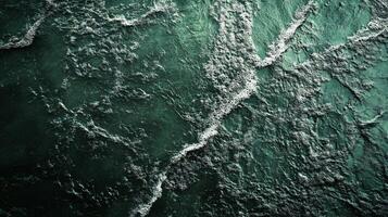 The image is of a body of water with a lot of foam and bubbles. The water appears to be choppy and rough, giving the impression of a stormy sea photo