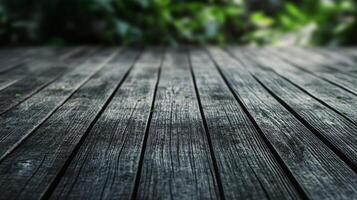 Wooden floor with a green leafy background. The floor is dark and the leaves are green photo