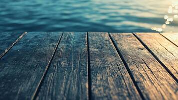 Wooden deck with a view of the water. The water is calm and the sun is shining on the deck photo