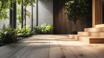 Large room with a wooden floor and a plant in the corner. The room is very bright and open, with a lot of natural light coming in through the windows. The plant adds a touch of greenery to the space photo