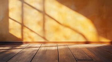 Room with a tan wall and wooden floor. The room is empty and has a lot of sunlight coming in through the window photo