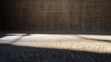 Close up of a patterned carpet with a shadow cast on it. The shadow is dark and the carpet is light photo