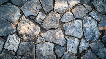 Stone wall with a blue and gray color. The wall is made of stones and has a rough texture photo