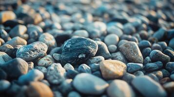 Pile of rocks with a blue rock in the middle. The rocks are scattered and the blue rock is the only one that stands out photo