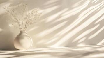 White vase with flowers sits on a table in front of a wall. The vase is empty, and the flowers are wilted. The scene is quiet and peaceful, with the vase and flowers as the only objects in the room photo