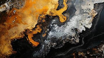 Painting of a black and gold swirl with a black background. The painting has a sense of movement and energy, with the gold and black colors blending together to create a dynamic photo