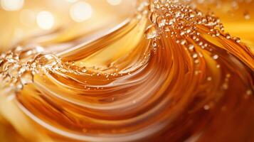 Swirl of liquid with bubbles in it. The bubbles are small and scattered throughout the liquid. The liquid appears to be a golden color photo