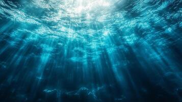 Beautiful blue ocean with sunlight shining through the water. The sunlight creates a serene and peaceful atmosphere, making the scene feel calm and relaxing photo