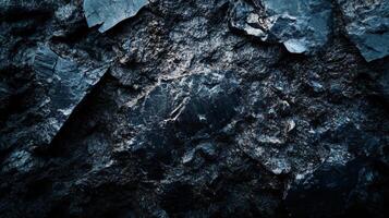 Dark blue background with a rock in the foreground. The rock is surrounded by water and the water is dark blue photo