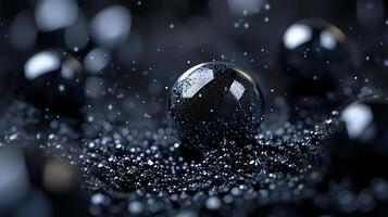 Black and white photo of a shiny, round object with a lot of glitter on it. The photo has a moody and mysterious feel to it, as the glitter seems to be falling from the object