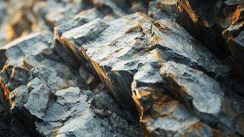 The image is of a rocky surface with a lot of texture and detail. The rocks are arranged in a way that creates a sense of depth and dimension. Scene is one of ruggedness and strength photo