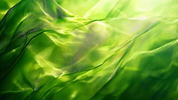 Green, flowing fabric with a pattern of green leaves. The image has a calming and peaceful mood, as the green fabric and leaves create a sense of nature and tranquility photo
