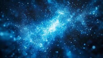 Blue galaxy with many stars and a blue background. The stars are scattered throughout the galaxy and appear to be twinkling. Scene is peaceful and serene, as if one were looking up at the night sky photo