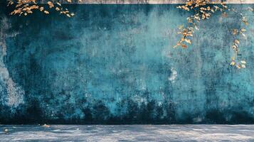 Blue wall with a tree on it. The wall is covered in graffiti and has a lot of leaves on it photo