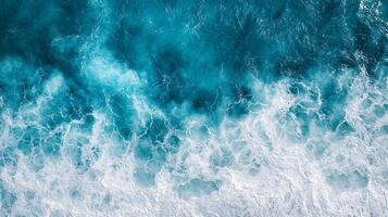 Large body of water with a lot of white foam and waves. The water appears to be calm, but the foam and waves suggest that there is some movement and energy in the water photo