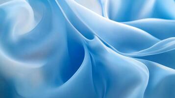 Piece of fabric with a blue color and a pattern of waves. The waves are in different sizes and are spread across the fabric. The fabric has a smooth texture and he is made of a lightweight material photo