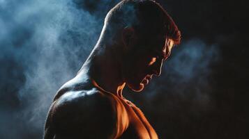 Man is standing in the rain with his arms crossed. He is wearing a shirt and has sweat on his face photo