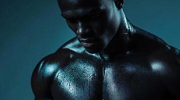 Man with a wet, shiny, and shiny body. The man is wearing a black shirt and is looking at the camera photo