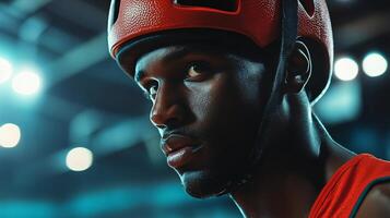 Man wearing a red helmet is looking at the camera. The image has a moody and intense feel to it, as if the man is preparing for a fight or a dangerous situation photo