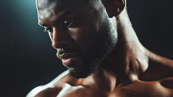 Man with a beard and sweat on his face. He is looking at the camera. Scene is intense and focused photo