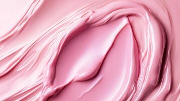 Pink blob of makeup is spread across a surface. The makeup is thick and creamy, with a slightly grainy texture. The color is a deep, rich pink, and it is a foundation or concealer photo