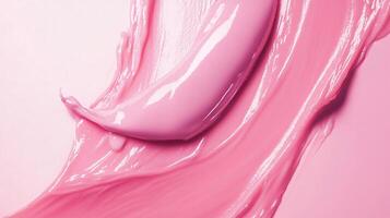 Pink liquid is splashed across a white background. The liquid is thick and has a glossy texture photo