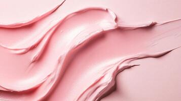 Pink color makeup brush is shown in the image. The brush is used to apply makeup on the face. The brush is in the middle of the image, and it is surrounded by a pink background photo