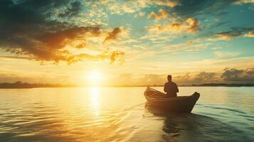 Man is sitting in a boat on a lake, with the sun setting in the background. The scene is peaceful and serene, with the man enjoying the calm waters and the beautiful sunset photo