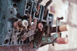 an old broken switch mechanism in which the insides with small wires, bolts and other electrically conductive filling. Old plastic copper and silver contacts. depressing post-apocalyptic View of a photo